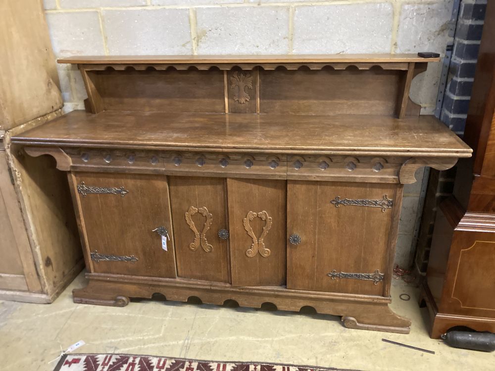 A 1930s oak Gothic inspired sideboard, width 180cm depth 50cm height 116cm